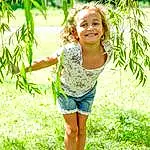 Face, Smile, Plant, Eyes, People In Nature, Happy, Sunlight, Grass, Waist, Leisure, T-shirt, Day Dress, Toddler, Fun, Shrub, Recreation, Forest, Pattern, Grassland, Person, Joy