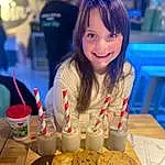 Food, Smile, Blue, Table, Tableware, Yellow, Happy, People, Child, Plate, Youth, Event, Recreation, Cooking, Fun, Chair, Dessert, Cuisine, Finger Food, Comfort Food, Person, Joy