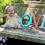 Smile, Plant, Wood, Happy, Grass, Dress, People In Nature, Baby & Toddler Clothing, Leisure, Summer, Recreation, Toddler, Fun, Landscape, Sitting, Font, Spring, Garden, Magenta, Child, Person, Joy