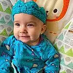 Green, Blue, Azure, Textile, Yellow, Baby, Aqua, Baby & Toddler Clothing, Toddler, Pattern, Linens, Happy, Electric Blue, Event, Fashion Accessory, Child, Smile, Room, Baby Products, Hat, Person, Headwear