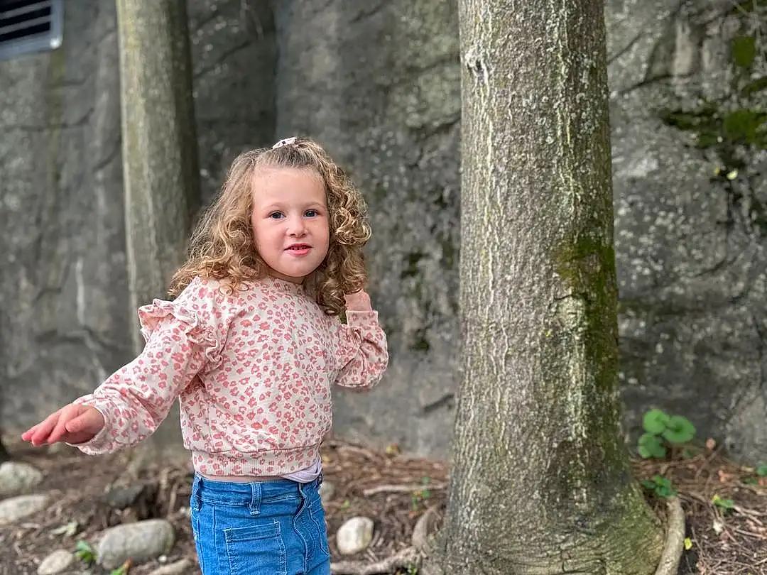 Eyes, Smile, People In Nature, Branch, Plant, Wood, Trunk, Grass, Woody Plant, Happy, Forest, Tree, Toddler, Woodland, Denim, Blond, Fun, Soil, Wilderness, Person, Joy