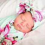 Comfort, Baby & Toddler Clothing, Textile, Sleeve, Dress, Baby, Pink, Petal, Baby Sleeping, Toddler, Magenta, Linens, Pattern, Headband, Grass, Child, Bedding, Headpiece, Fashion Accessory, Rose, Person, Headwear
