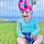 Clothing, Face, Head, Smile, Eyes, People In Nature, Happy, Baby & Toddler Clothing, Sunlight, Grass, Flash Photography, Pink, Toddler, Electric Blue, Grassland, Child, Leisure, Fun, Baby, Magenta, Person, Headwear