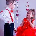 Hairstyle, Photograph, One-piece Garment, White, Smile, Dress, Fashion, Happy, Sleeve, Baby & Toddler Clothing, Standing, Gesture, Day Dress, Pink, Red, Fashion Design, Entertainment, Toddler, Bow Tie, Fun, Person, Joy