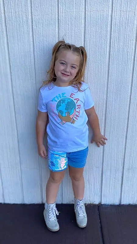 Clothing, Hair, Face, Shoe, Leg, Shorts, Smile, Neck, Sleeve, Standing, Happy, T-shirt, Baby & Toddler Clothing, Waist, Thigh, Toddler, Sneakers, Sportswear, Electric Blue, Trunk, Person, Joy