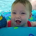 Smile, Facial Expression, Blue, Water, Azure, Happy, Baby Float, Iris, Fun, Toddler, Leisure, Baby Playing With Toys, Aqua, Recreation, Baby & Toddler Clothing, Baby, Child, Inflatable, Swimming Pool, Games, Person