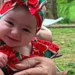 Face, Skin, Head, Lip, Hand, Photograph, Eyes, Mouth, Leaf, Smile, People In Nature, Happy, Finger, Gesture, Baby & Toddler Clothing, Grass, Red, Toddler, Thumb, Nail, Person, Joy, Headwear