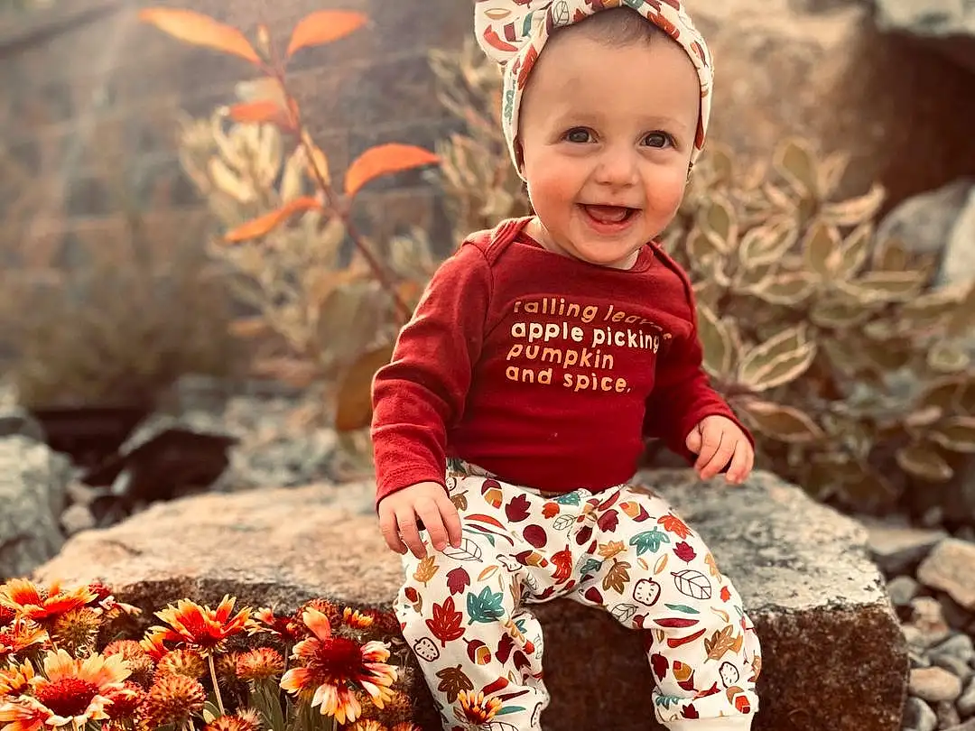 Face, Head, Smile, Eyes, Plant, Leaf, Happy, Orange, People In Nature, Flash Photography, Baby & Toddler Clothing, Flower, Red, Toddler, People, Grass, Child, Jewellery, Fun, Baby, Person, Joy