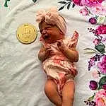 Skin, Hand, Textile, Petal, Happy, Pink, Finger, Comfort, Baby, Flower, Beauty, Baby Sleeping, Linens, Magenta, Pollinator, Child, Event, Baby & Toddler Clothing, Toddler, Peach
