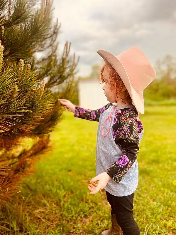 Sky, Cloud, Plant, Hat, People In Nature, Nature, Leaf, Flash Photography, Happy, Sun Hat, Grass, Sunlight, Baby, Natural Landscape, T-shirt, Toddler, Grassland, Landscape, Rural Area, Tree, Person