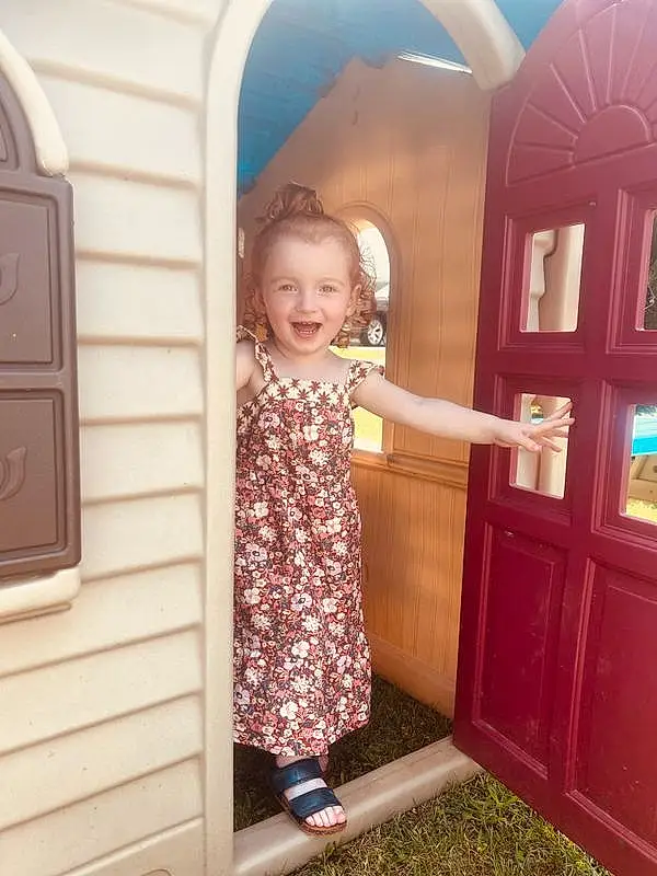 Skin, Hairstyle, Smile, Shoulder, Facial Expression, Door, Purple, Dress, Sleeve, Baby & Toddler Clothing, Standing, Wood, Pink, Happy, Fun, Window, Toddler, Summer, People, Person, Joy
