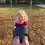 Smile, Arm, Nature, Human Body, Sleeve, Happy, Grass, People In Nature, Swing, Tree, Public Space, Plant, Fun, Playground, Woody Plant, Toddler, Summer, Leisure, Beauty, Person, Joy