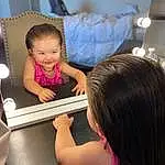 Skin, Hairstyle, Smile, Mouth, Fashion, Happy, Gesture, Pink, T-shirt, Table, Fun, Toddler, Leisure, Child, Electronic Device, Baby, Event, Vehicle Door, Gadget, Person, Joy