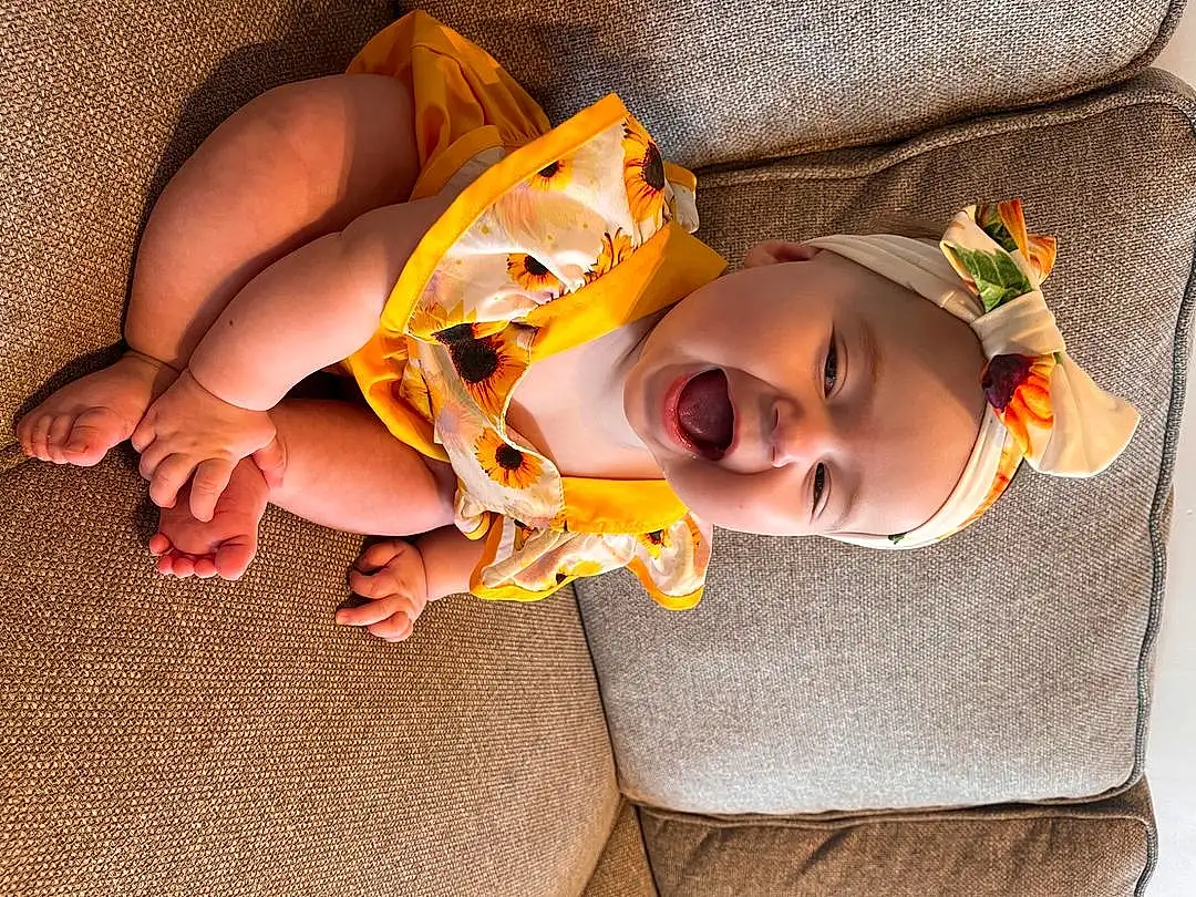 Skin, Head, Facial Expression, Mouth, Comfort, Human Body, Baby, Orange, Finger, Baby & Toddler Clothing, Smile, Toddler, Happy, Child, Linens, Hat, Fun, Human Leg, Foot, Thigh, Person, Headwear