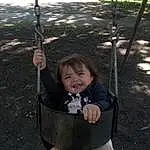 Smile, Light, Leaf, Black, Grass, Swing, Public Space, Playground, Toddler, Fun, Leisure, Human Settlement, City, Baby & Toddler Clothing, Recreation, Happy, Plant, Outdoor Play Equipment, Shade, Baby, Person, Joy