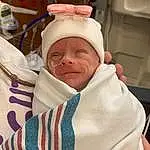 Cheek, Comfort, Finger, Headgear, Smile, Baby, Health Care, Hospital, Service, Medical, Toddler, Event, Medical Equipment, Thumb, Linens, Child, Happy, Room, Baby Safety, Furry friends, Person, Headwear