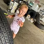 Tire, Hand, Wheel, Automotive Tire, Tread, Flash Photography, Synthetic Rubber, Wood, Hubcap, Happy, Toddler, T-shirt, Rolling, Tire Care, Vroom Vroom, Automotive Design, Leisure, Rim, Fun, Person, Joy