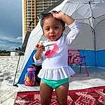 Sky, Building, Happy, Pink, Thigh, Cool, Umbrella, Leisure, Fun, Toddler, Recreation, Human Leg, Event, Travel, Knee, Child, Fashion Accessory, Magenta, Sitting, Vacation, Person