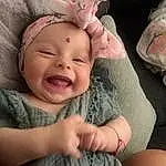 Nose, Cheek, Skin, Lip, Hand, Eyes, Facial Expression, Mouth, Smile, Comfort, Human Body, Ear, Textile, Gesture, Finger, Pink, Happy, Baby & Toddler Clothing, Person, Headwear
