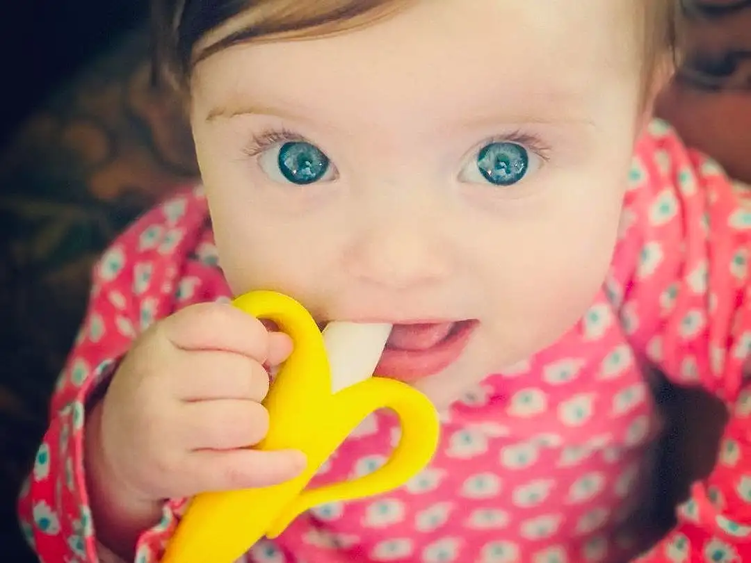 Nose, Cheek, Skin, Lip, Hand, Baby Playing With Toys, Mouth, Eyebrow, Facial Expression, Smile, Eyelash, Ear, Iris, Baby & Toddler Clothing, Happy, Gesture, Finger, Toddler, Baby