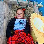 Blue, Green, Tartan, Baby & Toddler Clothing, Smile, Happy, People In Nature, Red, Plaid, Wood, Toddler, Baby, Toy, Pattern, Grass, Sitting, Child, Fun, Costume, Holiday, Person, Joy