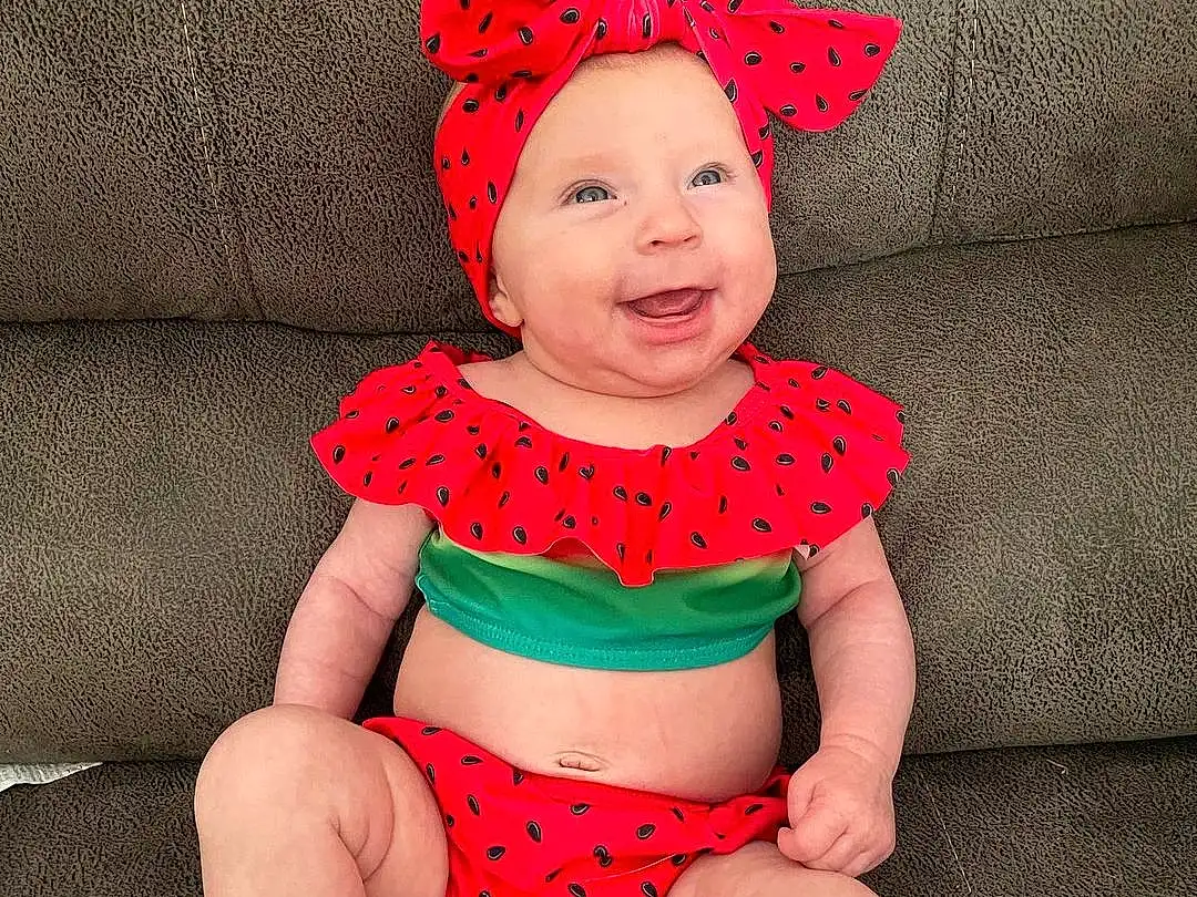 Face, Skin, Head, Glasses, Smile, Leg, Baby & Toddler Clothing, Human Body, Shorts, Sleeve, Thigh, Pink, Happy, Red, Baby, Headgear, Toddler, Waist, Knee, Costume Hat, Person, Headwear