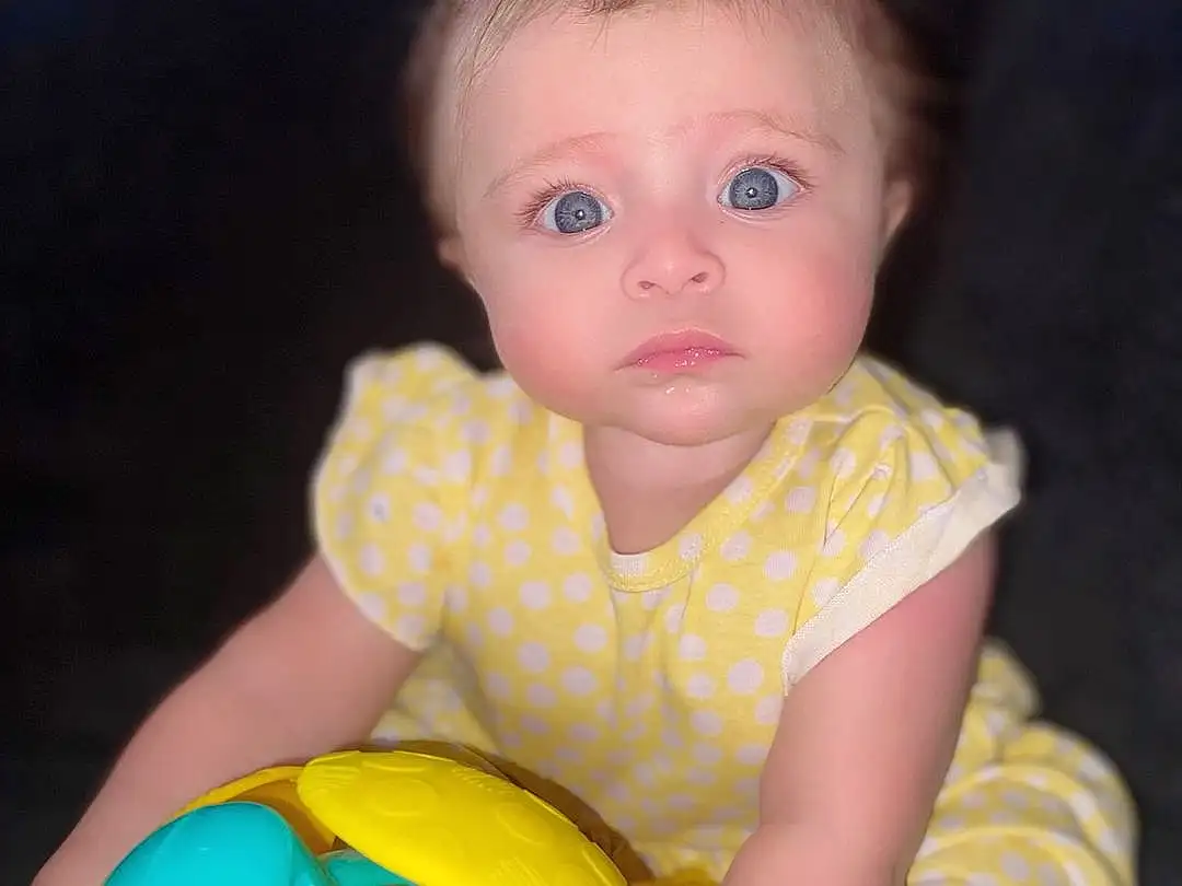 Nose, Cheek, Skin, Head, Photograph, Arm, Eyes, Facial Expression, Baby Playing With Toys, Baby & Toddler Clothing, Iris, Yellow, Pink, Happy, Baby, Toddler, Fun, Child, Beauty, Person