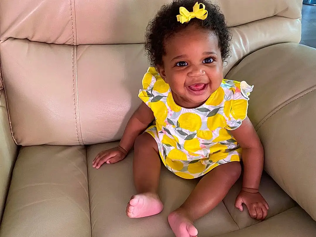 Face, Hair, Skin, Head, Smile, Hairstyle, Arm, Eyes, Facial Expression, Dress, Comfort, Baby & Toddler Clothing, Human Body, Sleeve, Flash Photography, Iris, Yellow, Finger, Happy, Pink, Person, Joy