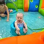 Photograph, Blue, Smile, Green, Azure, Water, Fun, Yellow, Leisure, Aqua, Red, Recreation, Toddler, Happy, Baby, Inflatable, Bounce House, Child, Swimming Pool, Person
