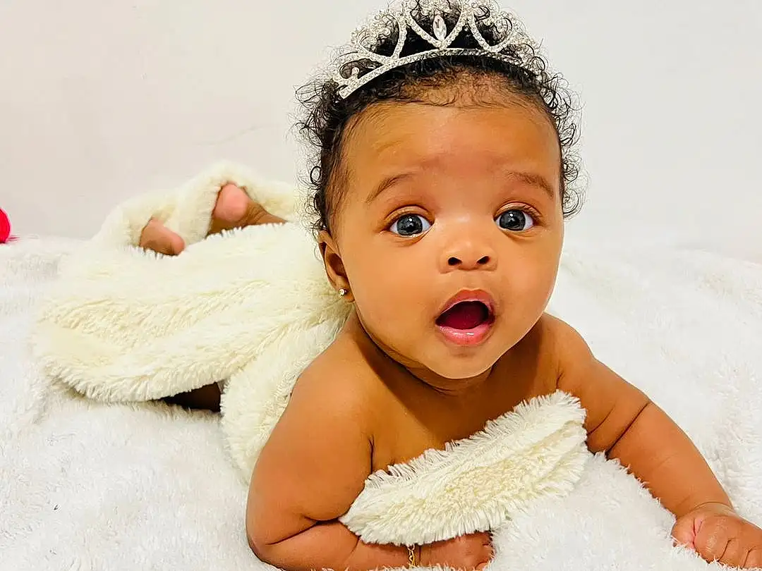 Skin, Arm, Flash Photography, Ear, Baby, Baby & Toddler Clothing, Happy, Toddler, Headpiece, Headband, Comfort, Hair Accessory, Blond, Jewellery, Fashion Accessory, Fun, Sitting, Wood, Bathing, Person