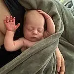 Cheek, Skin, Head, Hand, Arm, Comfort, Sleeve, Baby, Gesture, Finger, Baby & Toddler Clothing, Thumb, Toddler, Baby Sleeping, Linens, Child, Baby Products, Nail, Sitting, Pattern, Person