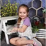 Face, Smile, Plant, Shoe, Leg, Flower, Table, Dress, Chair, Happy, Pink, Grass, Baby & Toddler Clothing, Thigh, Outdoor Furniture, Beauty, Petal, Toddler, Lap, Magenta, Person, Joy