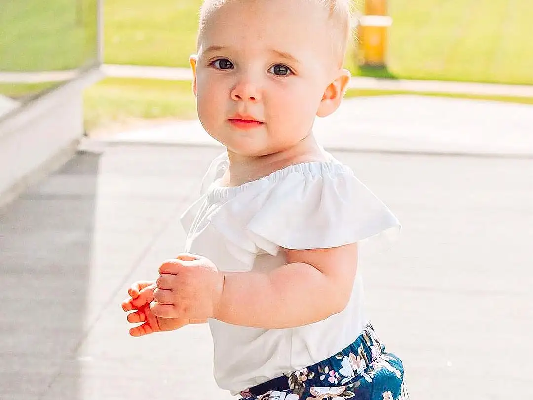 Joint, Skin, Photograph, Shoulder, Facial Expression, White, Neck, Sleeve, Waist, Happy, Street Fashion, Pink, Thigh, Baby & Toddler Clothing, Knee, T-shirt, Summer, Toddler, Trunk, Day Dress, Person