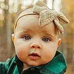 Clothing, Nose, Cheek, Skin, Lip, Eyebrow, Eyes, Plant, Eyelash, Sleeve, Iris, Baby & Toddler Clothing, Collar, Happy, Baby, Toddler, Grass, Close-up, Blond, Wood, Person