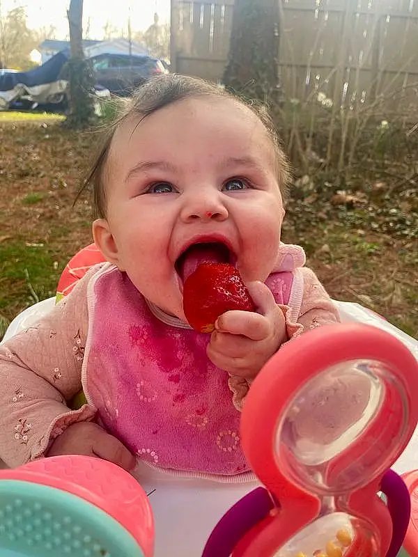 Nose, Cheek, Lip, Food, Plant, Mouth, Tableware, Happy, Fruit, Food Craving, Pink, Grass, Baby, Toddler, Natural Foods, Sharing, Fun, Tree, Baby & Toddler Clothing, Sweetness, Person