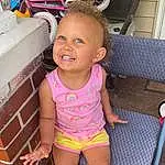 Face, Cheek, Skin, Head, Smile, Hairstyle, Facial Expression, Leg, Mouth, Human Body, Neck, Baby & Toddler Clothing, Pink, Thigh, Shorts, Happy, Toddler, Summer, Fun, Person, Joy