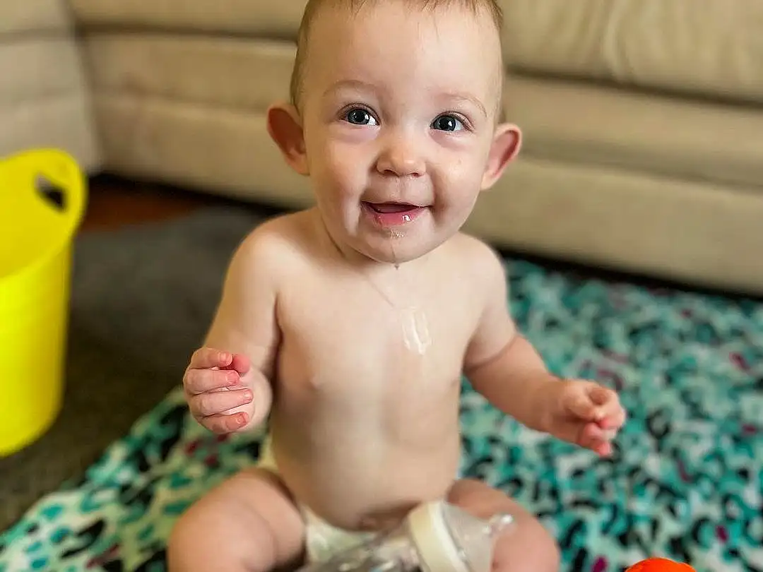 Face, Smile, Cheek, Skin, Head, Photograph, Eyes, Yellow, Toy, Iris, Baby, Baby Playing With Toys, Happy, Toddler, Fun, Child, Baby & Toddler Clothing, Baby Products, Play, Person, Joy