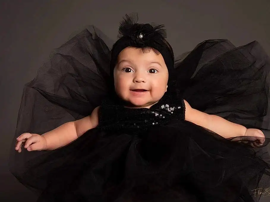 Cheek, Smile, Eyebrow, Flash Photography, Sleeve, Iris, Gesture, Happy, Baby & Toddler Clothing, Black Hair, Toddler, Baby, Furry friends, Sitting, Formal Wear, Child, Black & White, Monochrome, Darkness, Comfort, Person