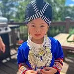 Face, Chin, Eyes, Textile, Neck, Temple, Happy, Fashion Design, Cap, Electric Blue, Headpiece, Jewellery, Hair Accessory, Event, Child, Pattern, Fashion Accessory, Tradition, Toddler, Necklace, Person, Headwear