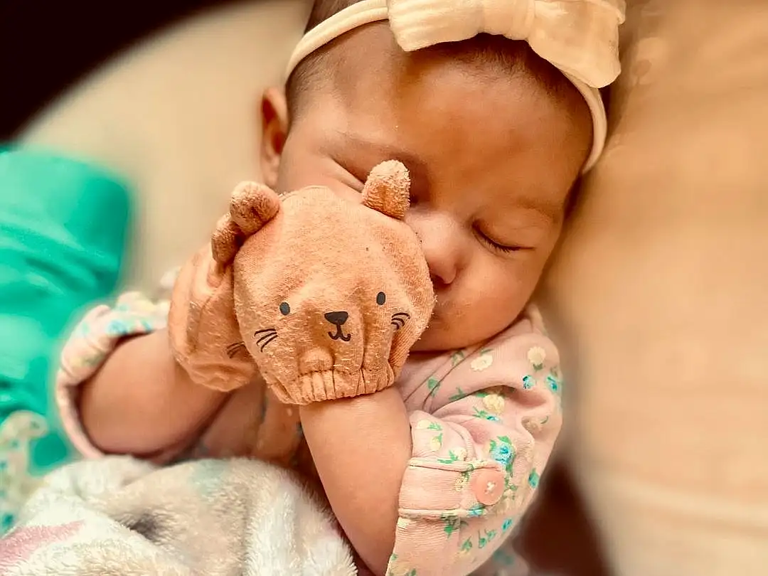 Nose, Cheek, Skin, Hand, Arm, Comfort, Textile, Baby Sleeping, Baby & Toddler Clothing, Baby, Pink, Finger, Headgear, Happy, Fawn, Toy, Toddler, Child, Linens, Nail, Person