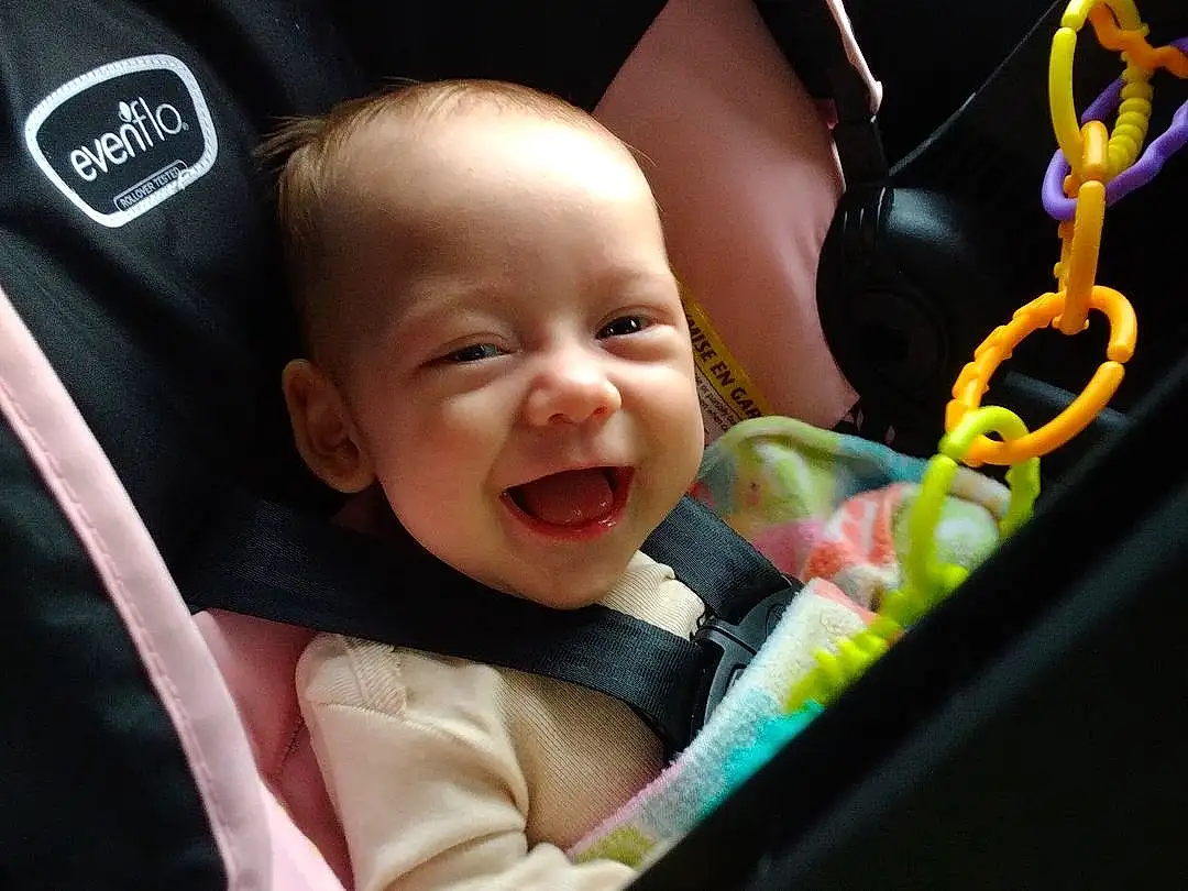 Cheek, Facial Expression, Baby Carriage, Smile, Baby, Comfort, Happy, Toddler, Automotive Design, Car Seat, Child, Fun, Auto Part, Baby Products, Baby & Toddler Clothing, Baby In Car Seat, Vroom Vroom, Sitting, Steering Wheel, Grass, Person