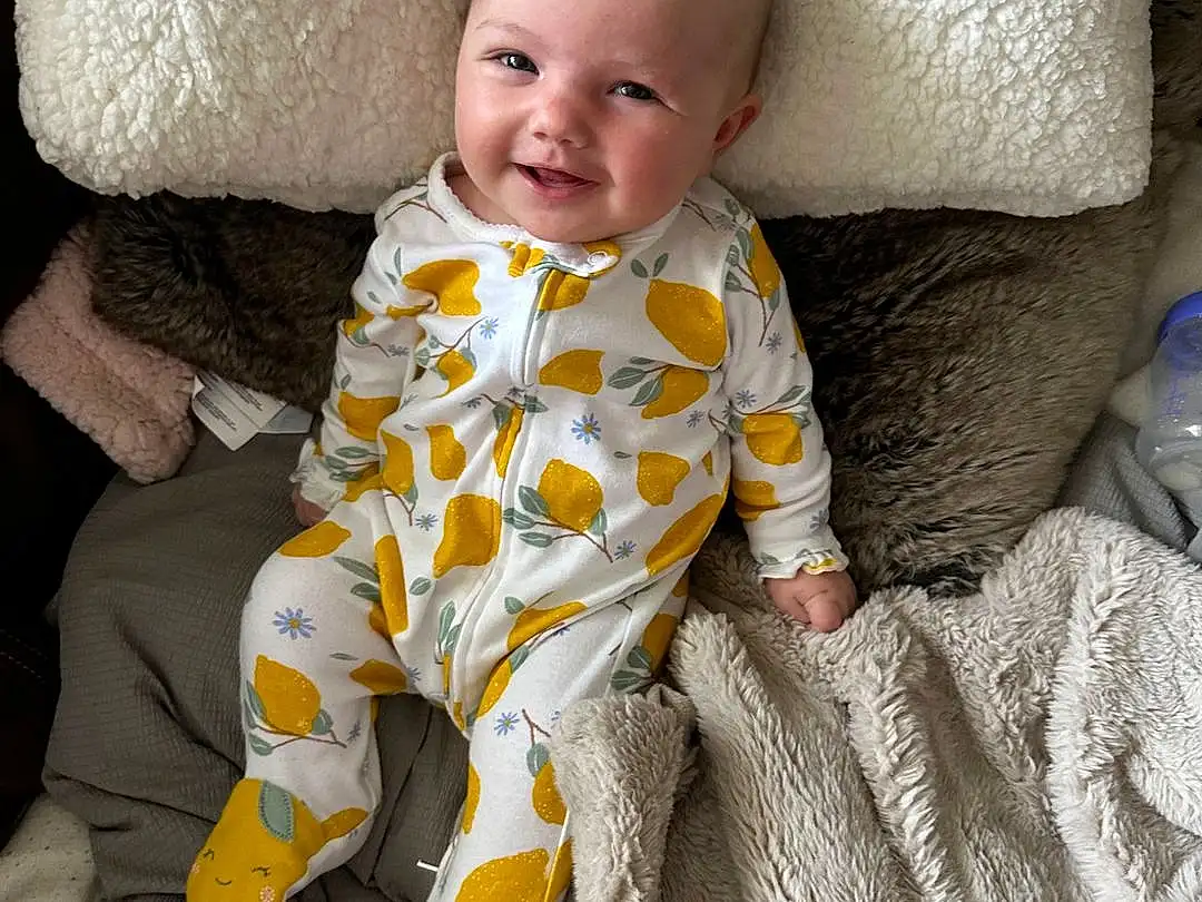 Smile, Comfort, Baby & Toddler Clothing, Baby, Toddler, Linens, Bedding, Child, Sitting, Room, Nap, Furry friends, Bedtime, Pattern, Sleep, Foot, Nightwear, Blanket, Sleeve, Person, Joy