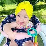 Smile, Skin, Plant, Facial Expression, White, Leg, Blue, Purple, Tree, Baby & Toddler Clothing, Happy, Yellow, Pink, Grass, Toddler, Leisure, Fun, Thigh, Personal Protective Equipment, Recreation, Person, Headwear