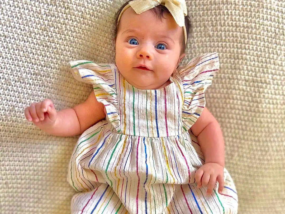 Eyes, Dress, Baby & Toddler Clothing, Textile, Sleeve, One-piece Garment, Iris, Day Dress, Pattern, Beauty, Toddler, Sock, Ruffle, Fashion Design, Peach, Baby, Fashion Accessory, Brown Hair, Child, Wig, Person