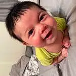 Forehead, Nose, Cheek, Skin, Smile, Lip, Chin, Eyebrow, Mouth, Eyelash, Ear, Neck, Jaw, Sleeve, Iris, Happy, Window, Gesture, Comfort, Baby & Toddler Clothing, Person