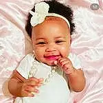 Smile, Cheek, Lip, Eyebrow, Eyelash, Ear, Neck, Baby & Toddler Clothing, Sleeve, Happy, Iris, Gesture, Pink, Finger, Baby, Thumb, Toddler, Headpiece, Headband, Jewellery, Person, Joy