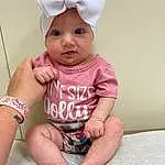 Skin, Chin, Arm, Eyes, Mouth, Baby & Toddler Clothing, Neck, Cap, Human Body, Textile, Sleeve, Finger, Pink, Baby, Comfort, Happy, Knee, Headgear, Toddler, Thigh, Person, Headwear