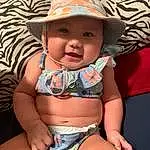 Face, Skin, Head, Smile, Hat, Eyes, Photograph, Sun Hat, Stomach, Baby & Toddler Clothing, Human Body, Happy, Thigh, Toddler, Baby, Cap, Summer, Trunk, Chest, Person, Headwear