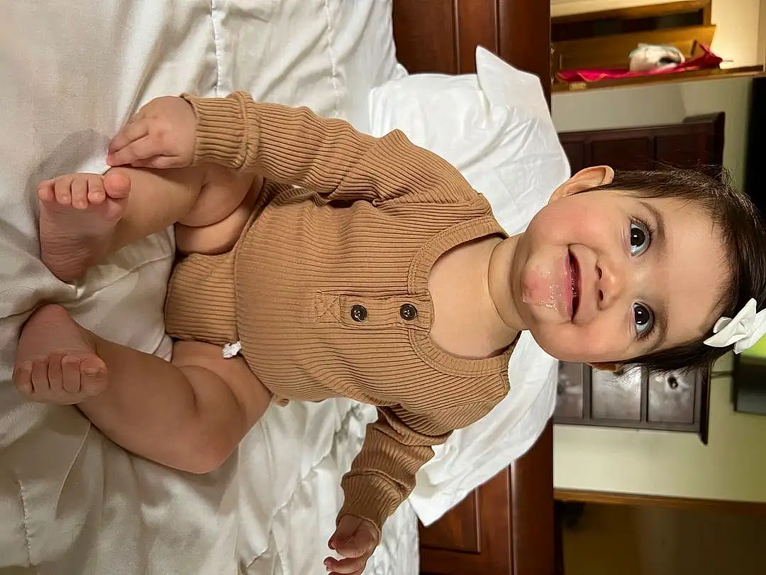 Skin, Head, Smile, Facial Expression, Leg, Comfort, Sleeve, Baby & Toddler Clothing, Gesture, Toddler, Finger, Child, Baby, Trunk, Thumb, Abdomen, Happy, Wood, Wrist, Thigh, Person, Joy