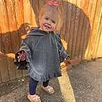 Clothing, Face, Hair, Footwear, Skin, Head, Smile, Hand, Shoe, Eyes, Leg, Dress, Sleeve, Standing, Baby & Toddler Clothing, Wood, Toddler, Happy, Grass, Person, Joy
